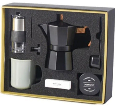 Luxury black coffee maker set with hand grinder and cup in gift box.